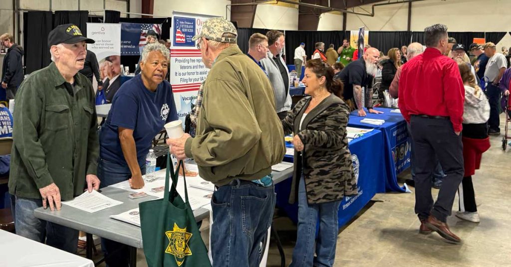 The Veterans Club members warmly engage with a fellow veteran at the North Idaho Stand Down, sharing stories, offering support, and building lasting connections.